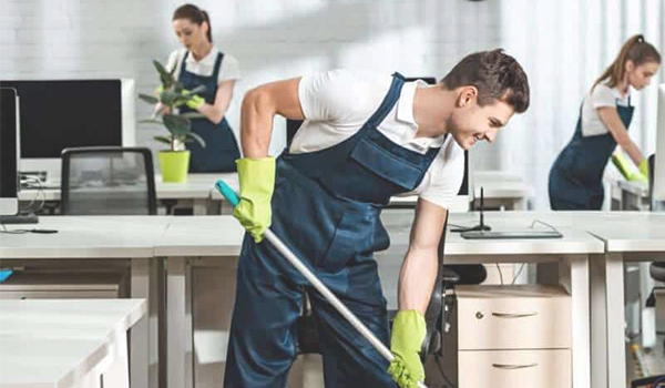 Office Cleaner team buffing floors and wiping desks