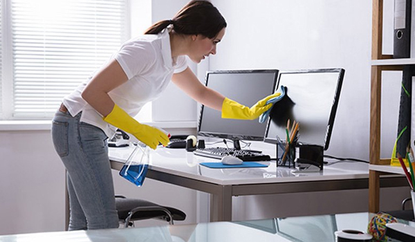 Office Cleaner team sweeping and mopping a bright hallway